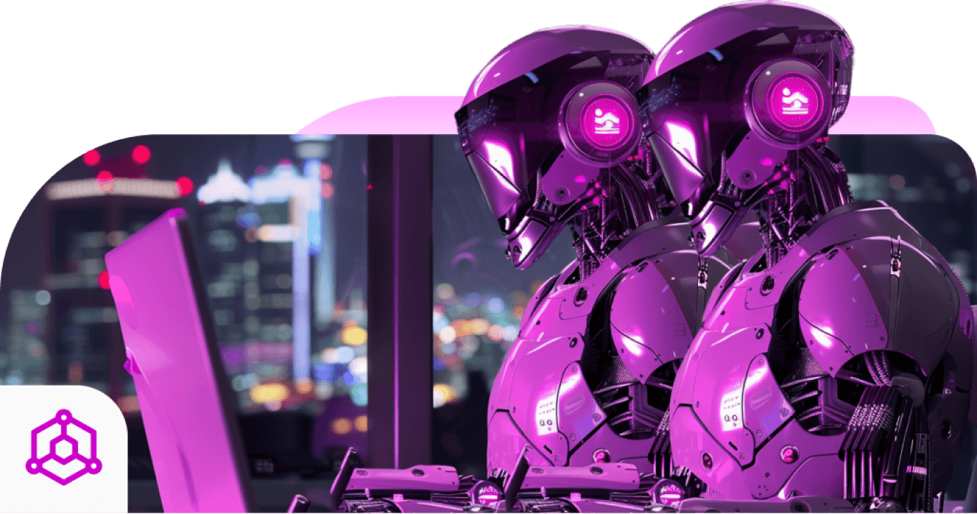 Two magenta robots at a laptop in front of a city skyline at night, with a blockchain cube badge