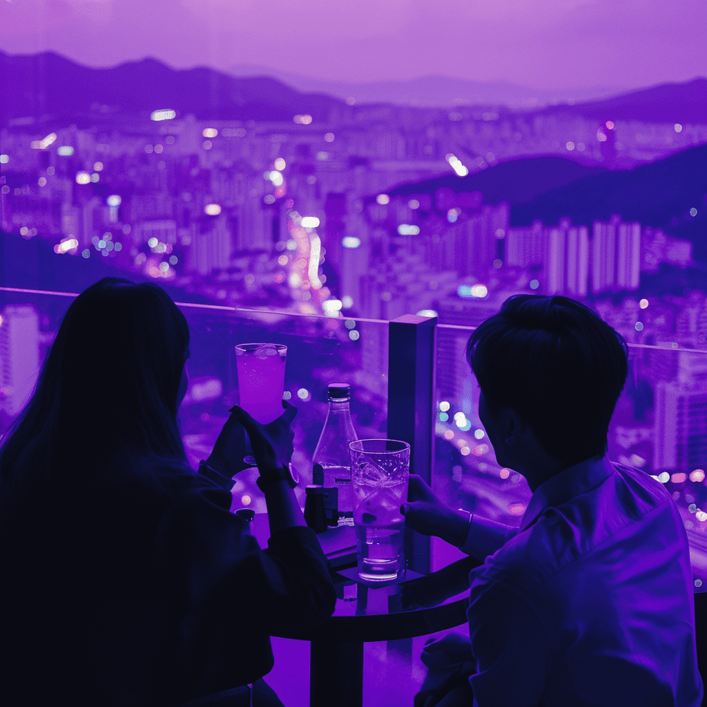 Two guests with drinks at a glass-railed terrace above a sprawling city lit in purple
