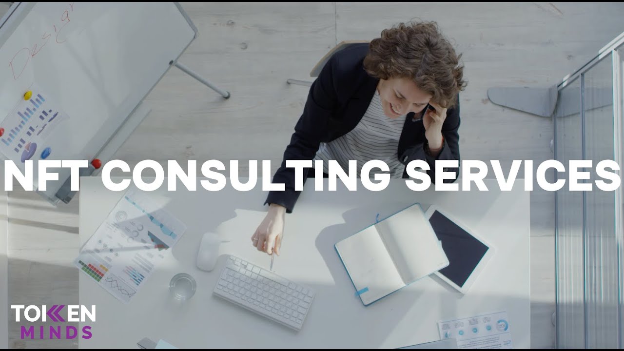 NFT Consulting Services: a consultant on the phone at a white desk, seen from above