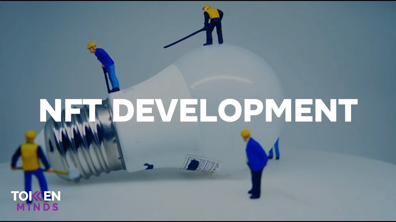 NFT Development: toy construction workers at work on a giant light bulb, with the TokenMinds logo