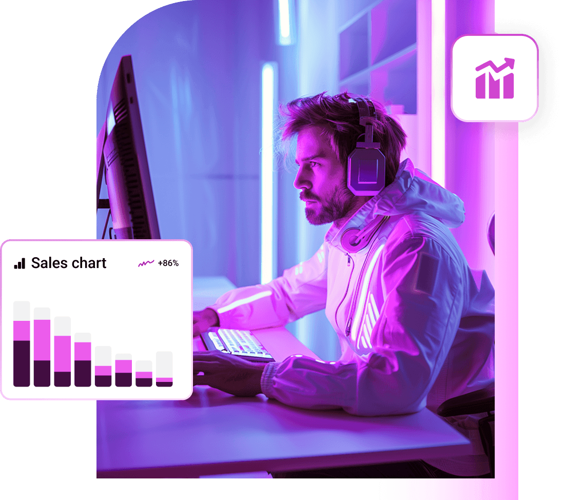 A developer in headphones at his desk, next to a sales chart